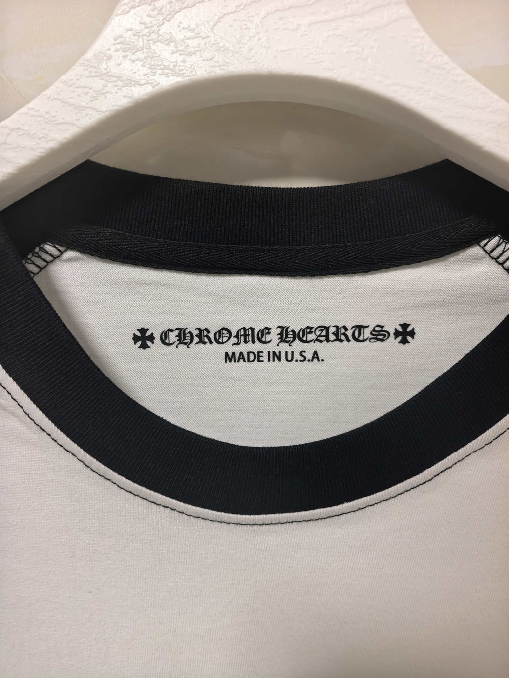 Ribbed black crew neckline with brand text and “MADE IN U.S.A.” on the inside