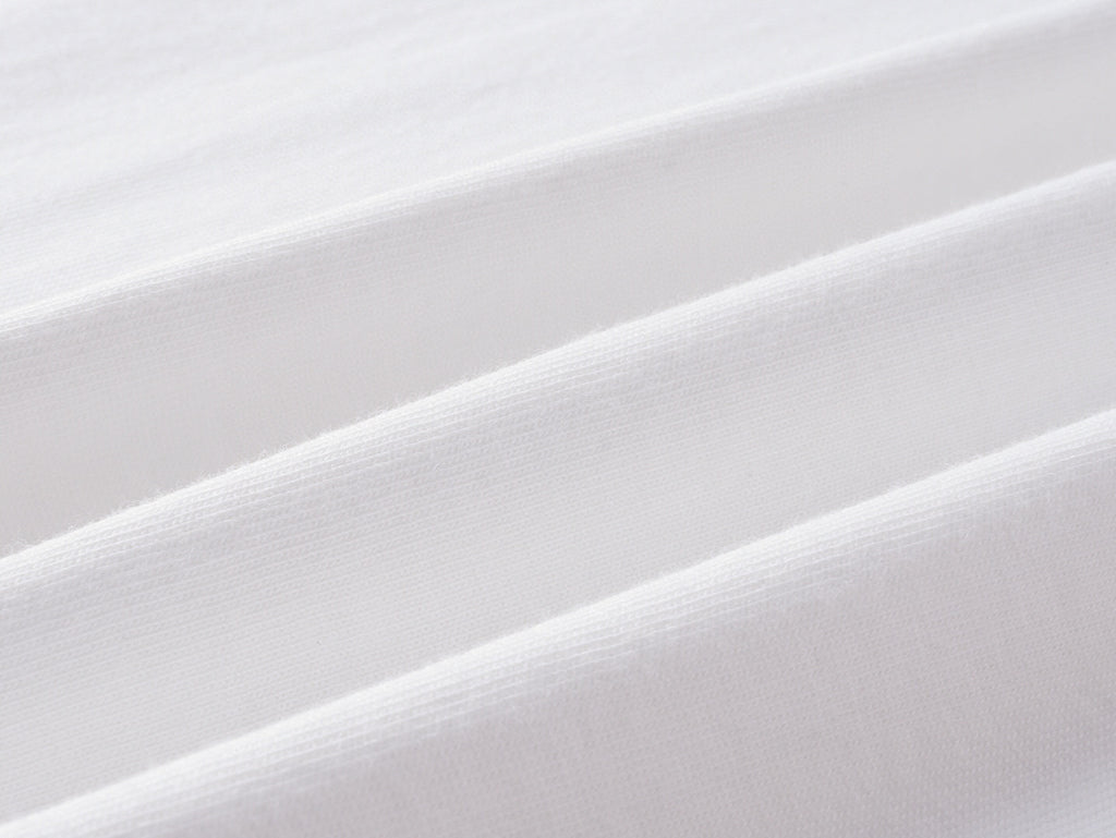 White knit fabric close-up with fine weave texture