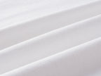 White knit fabric close-up with smooth textured weave
