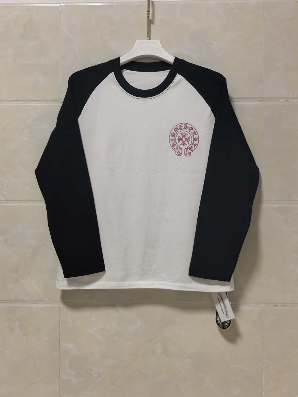 Black and white raglan long-sleeve T-shirt with red circular chest logo