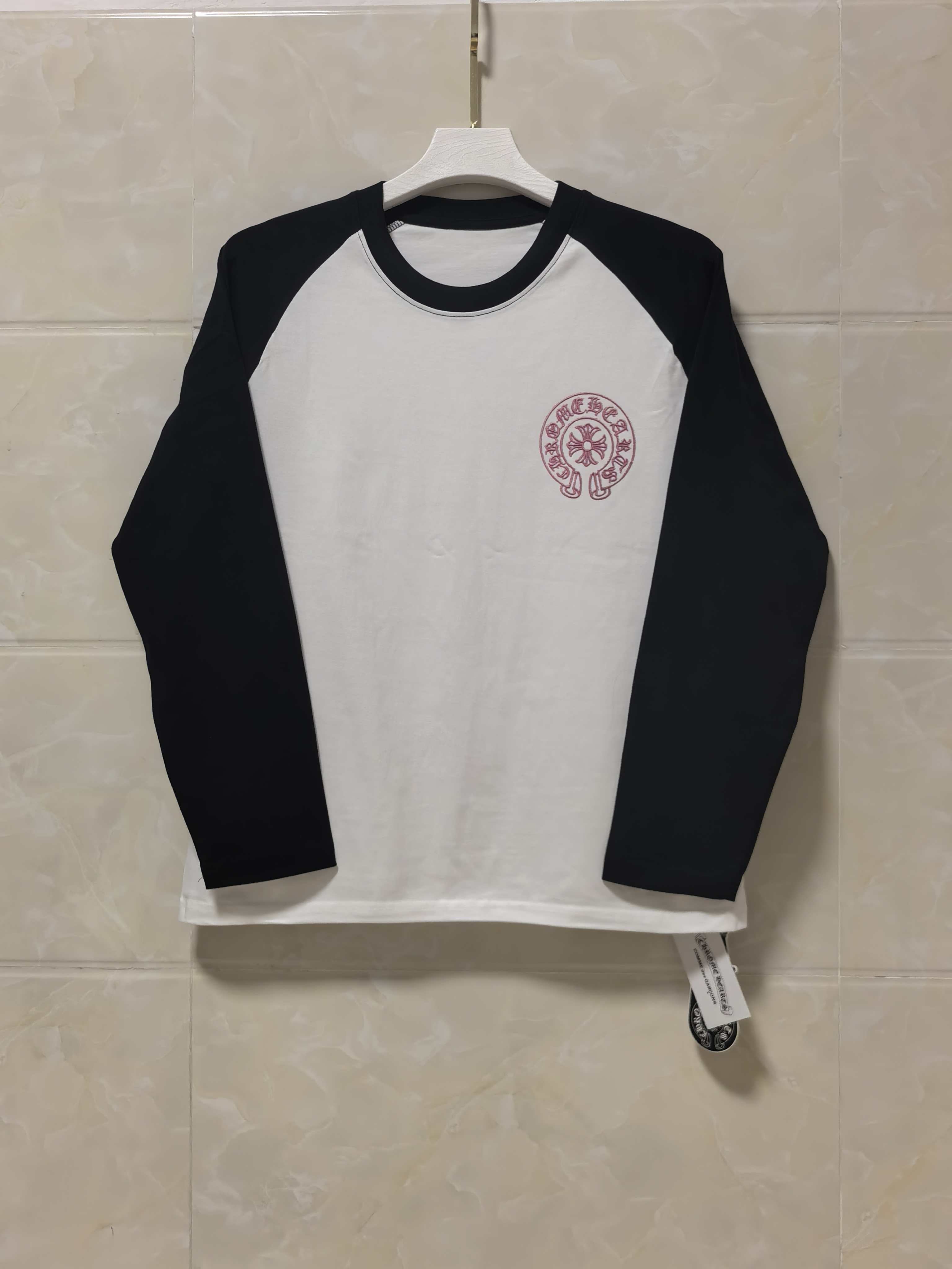 Raglan long-sleeve shirt with white body and black sleeves, maroon chest logo