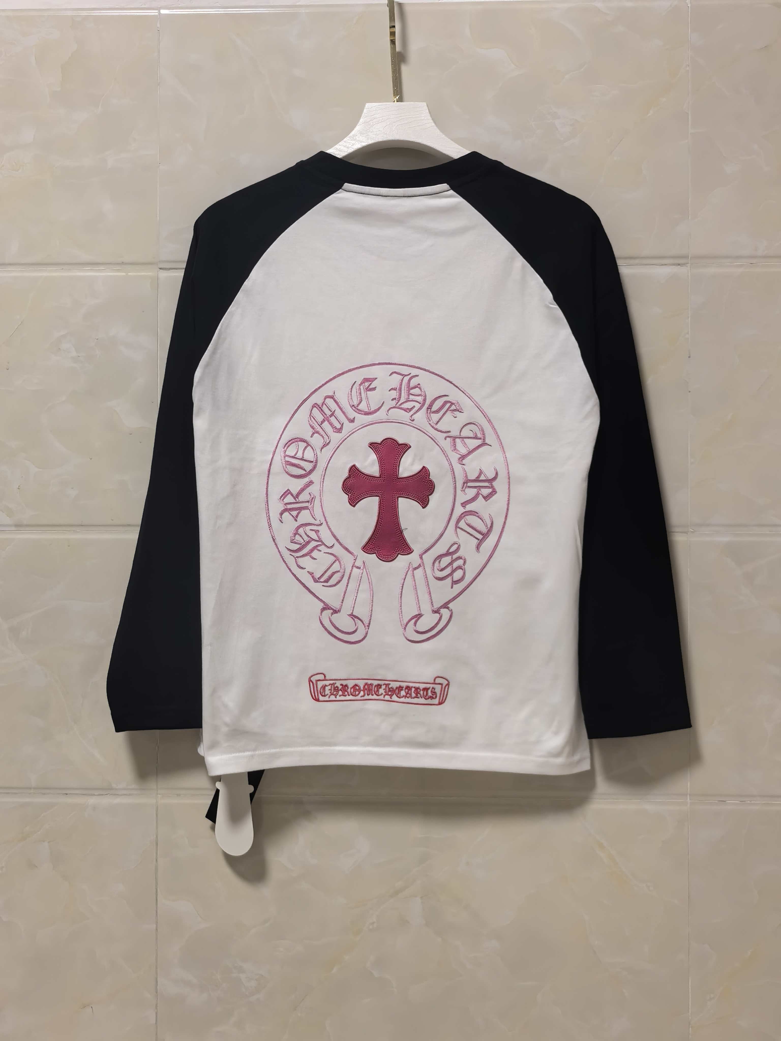 Raglan long-sleeve shirt, back view: white body with black sleeves and maroon emblem