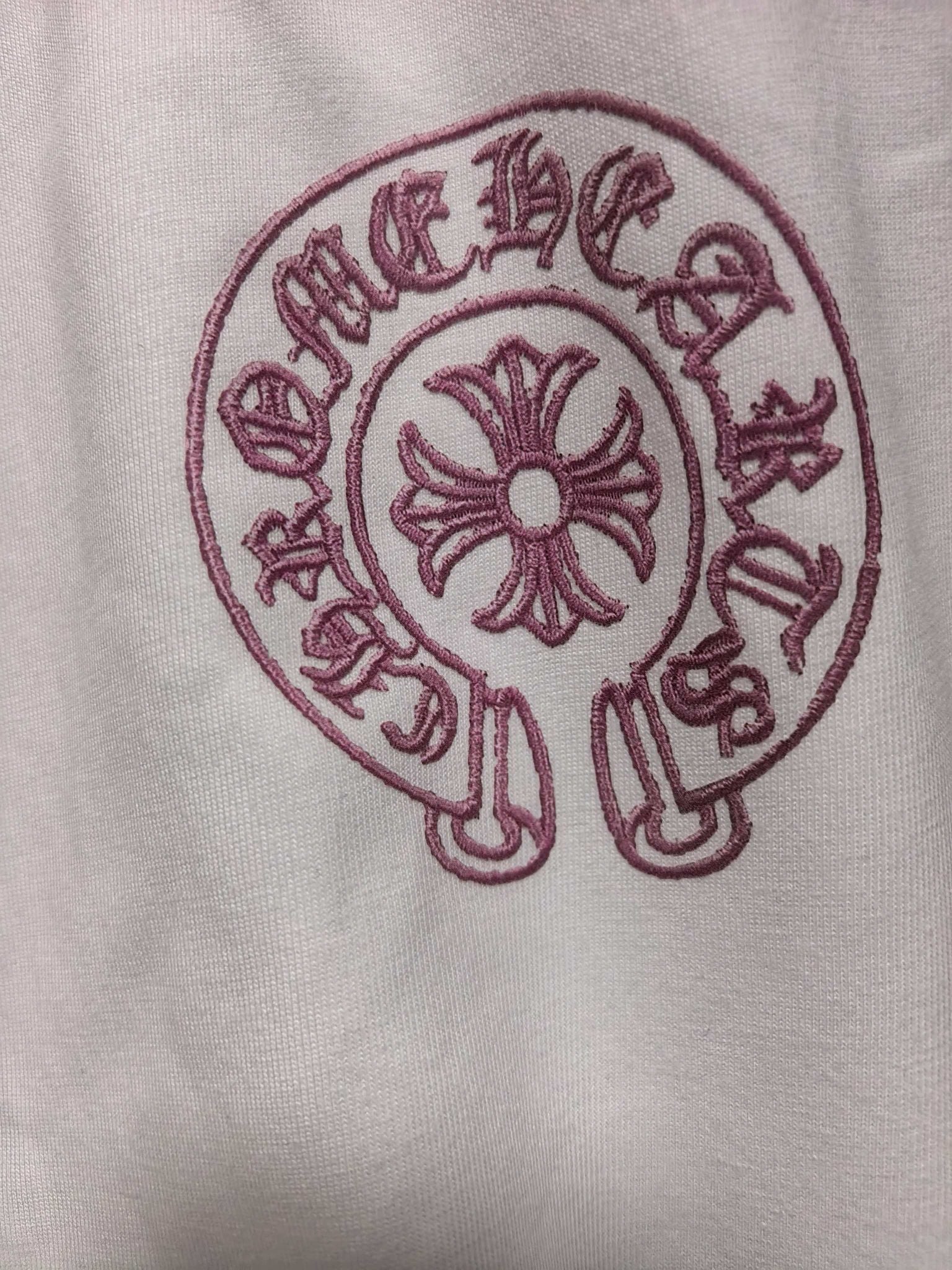 Long-sleeve shirt chest logo patch in maroon on light fabric