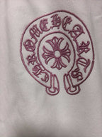 White long-sleeve T-shirt with red circular cross emblem close-up
