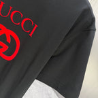 Black Gucci T-shirt sleeve and shoulder seam with red logo print detail
