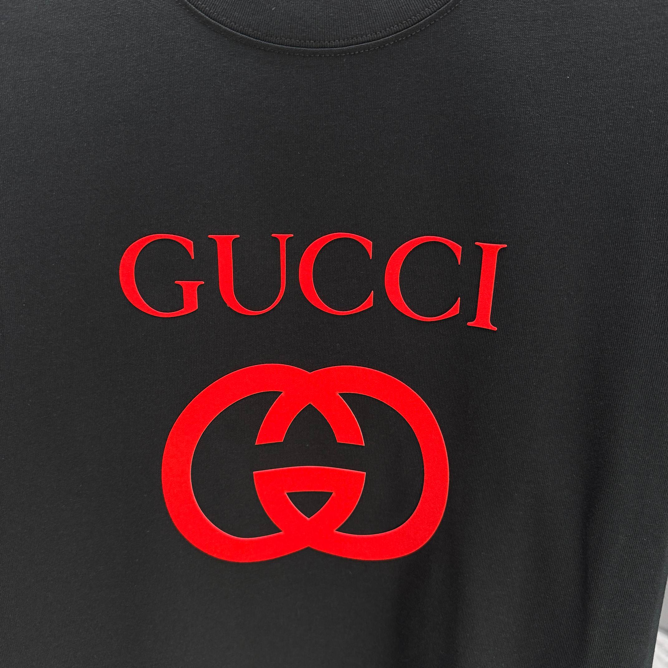 Black Gucci T-shirt chest graphic with red Gucci text and interlocking logo