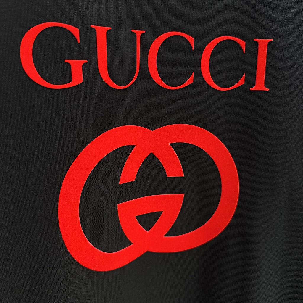 Black Gucci T-shirt close-up of red interlocking G logo