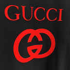 Black Gucci T-shirt close-up of red interlocking G logo