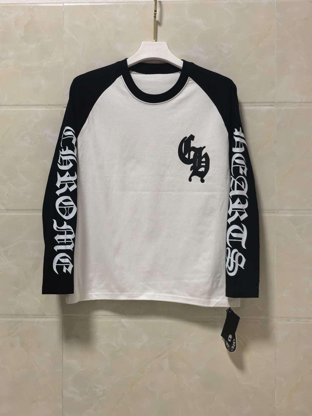 Long-sleeve raglan shirt, white body with black sleeves and front graphic print.