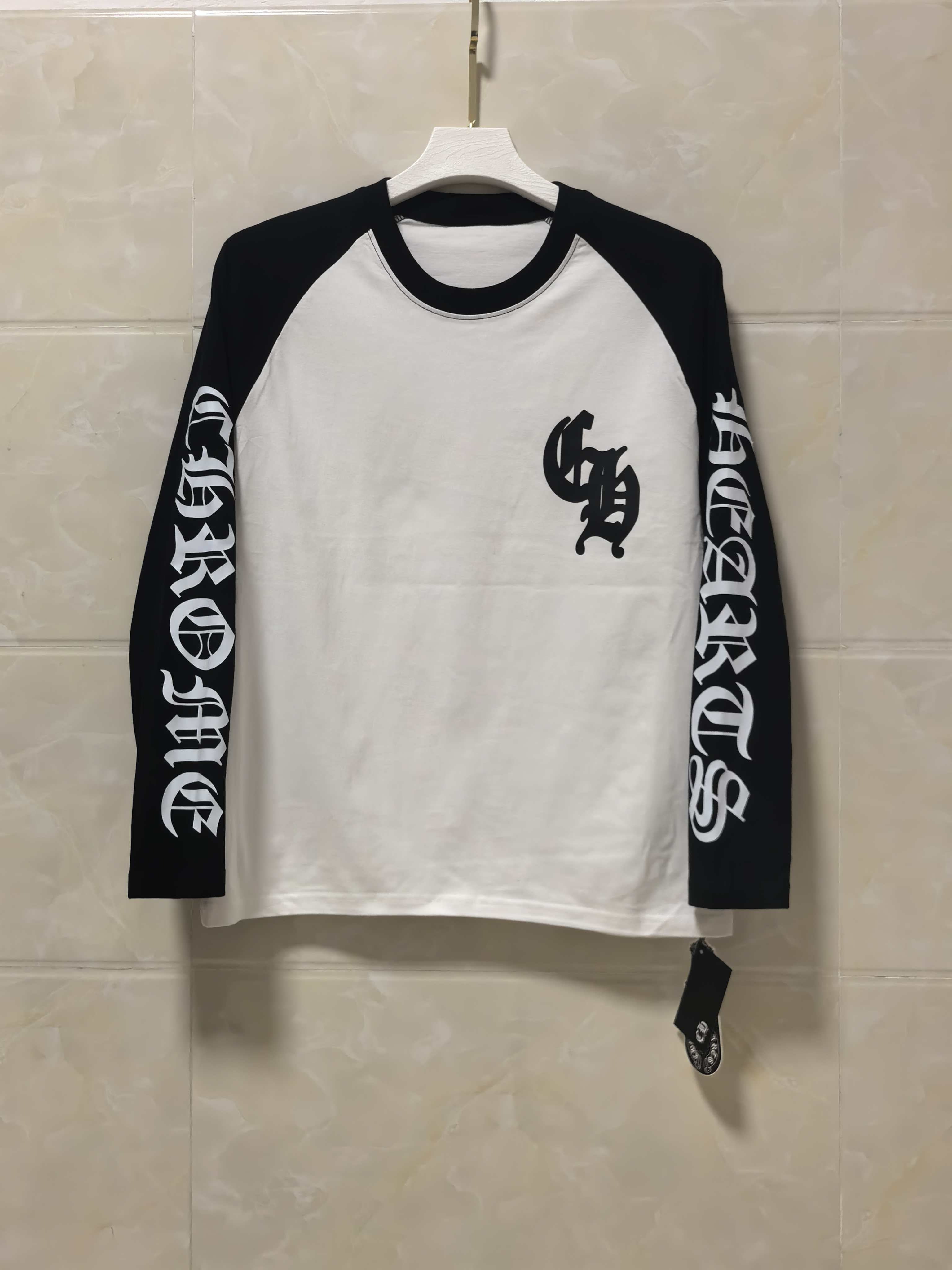 Long-sleeve raglan shirt, white body with black sleeves and front graphic print.
