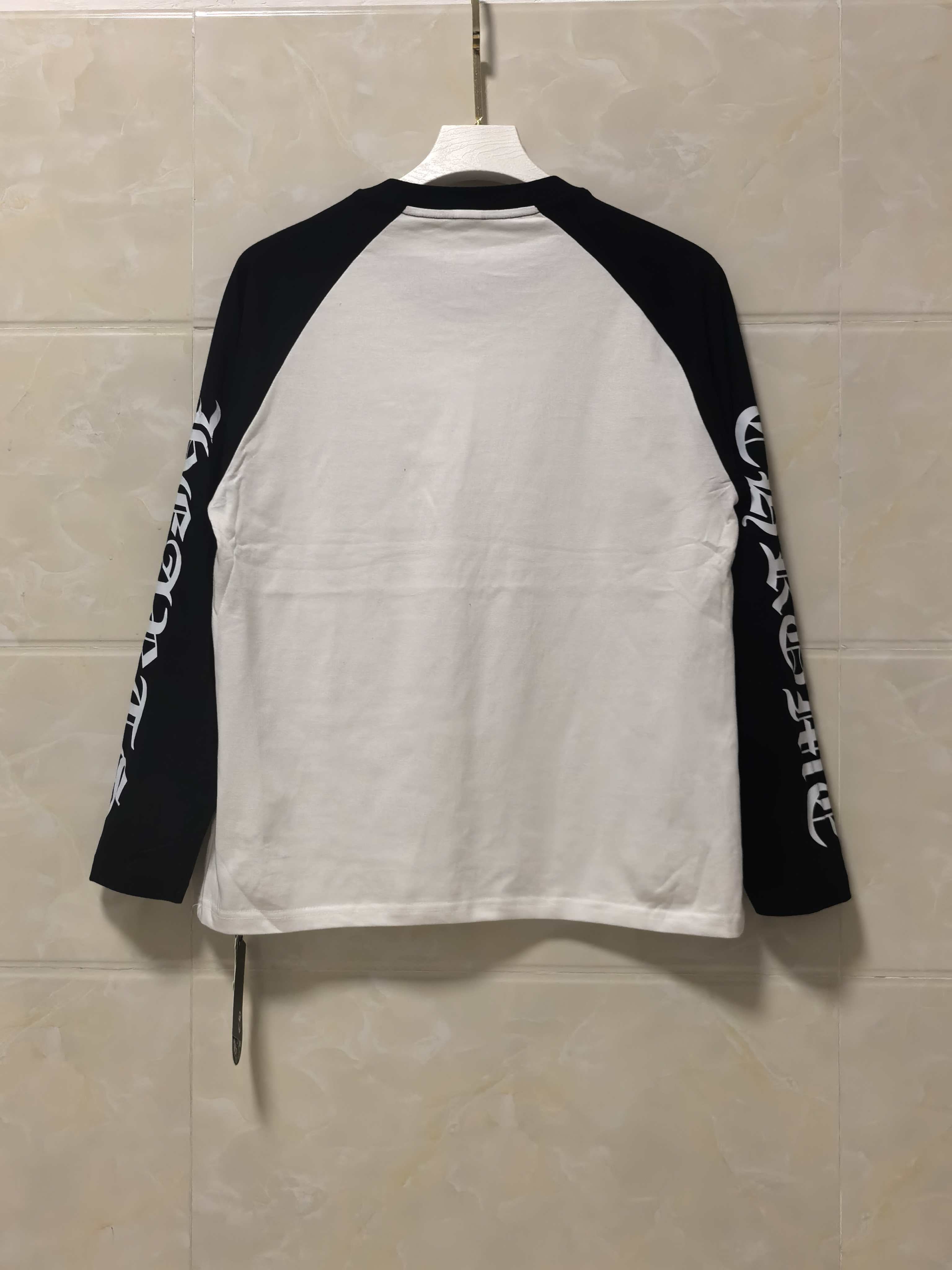 Long-sleeve raglan shirt, back view with white body, black sleeves, and sleeve text.
