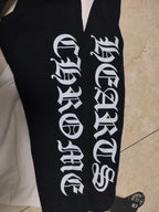 Long-sleeve shirt sleeve close-up with bold white lettering on black fabric.