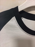 Long-sleeve shirt neck and collar trim in black with white body fabric.