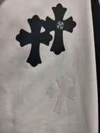 Long-sleeve T-shirt graphic, black cross and floral shapes on light fabric