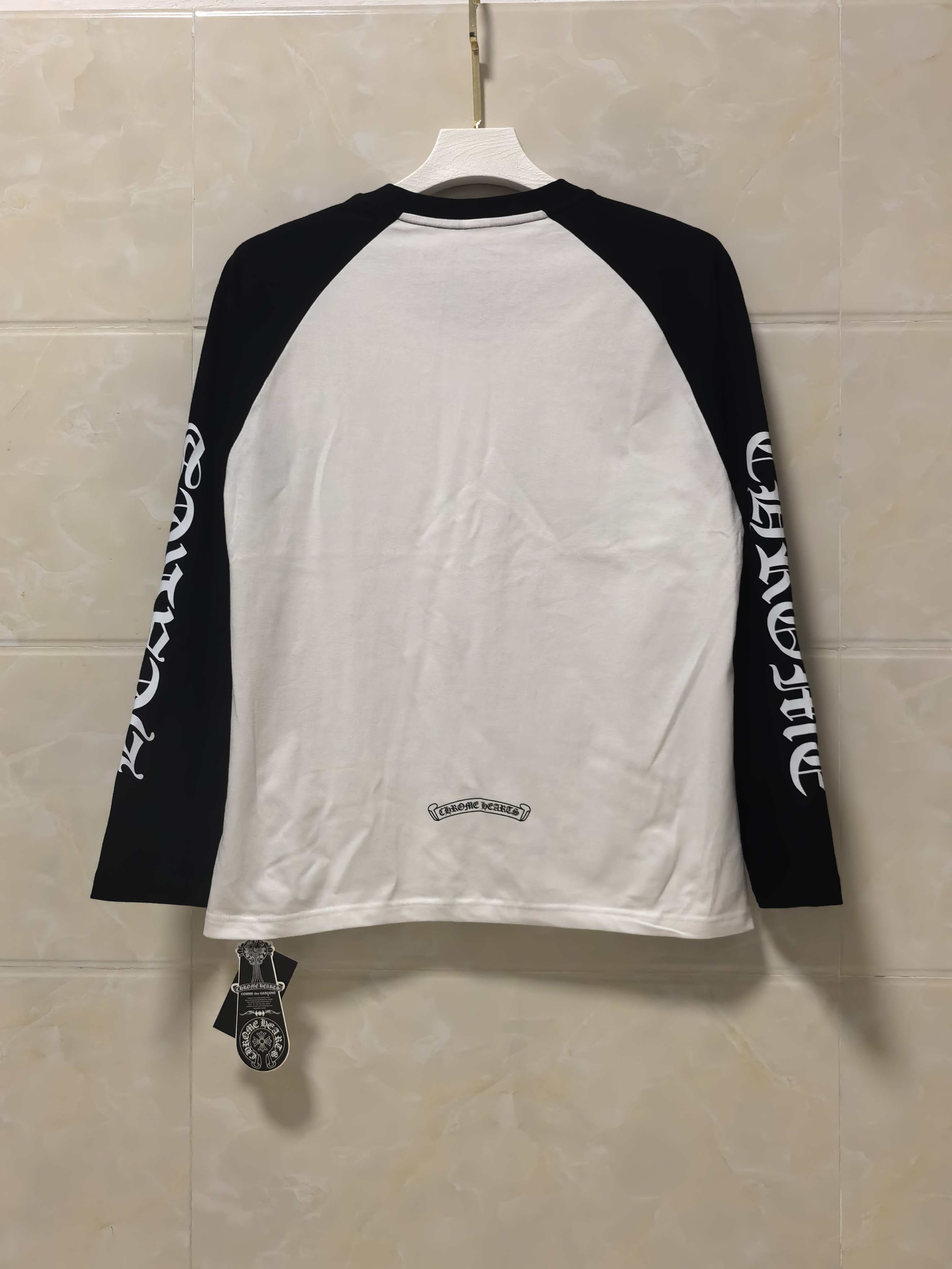 Back view raglan long-sleeve shirt, white body with black sleeves and small logo