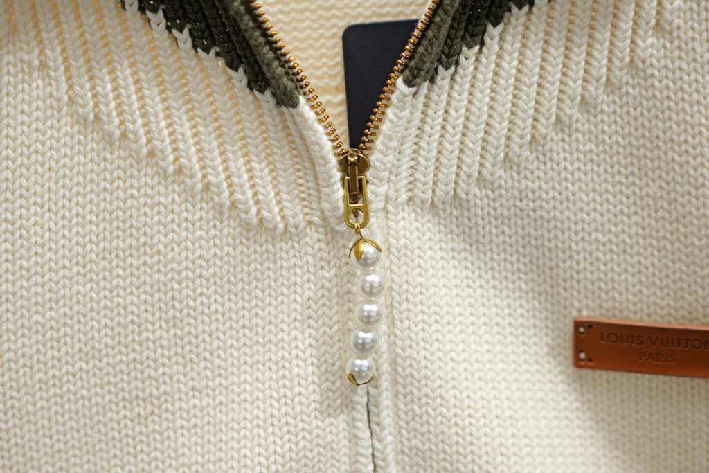 Ivory knit zip front with pearl bead trim and gold zipper pull