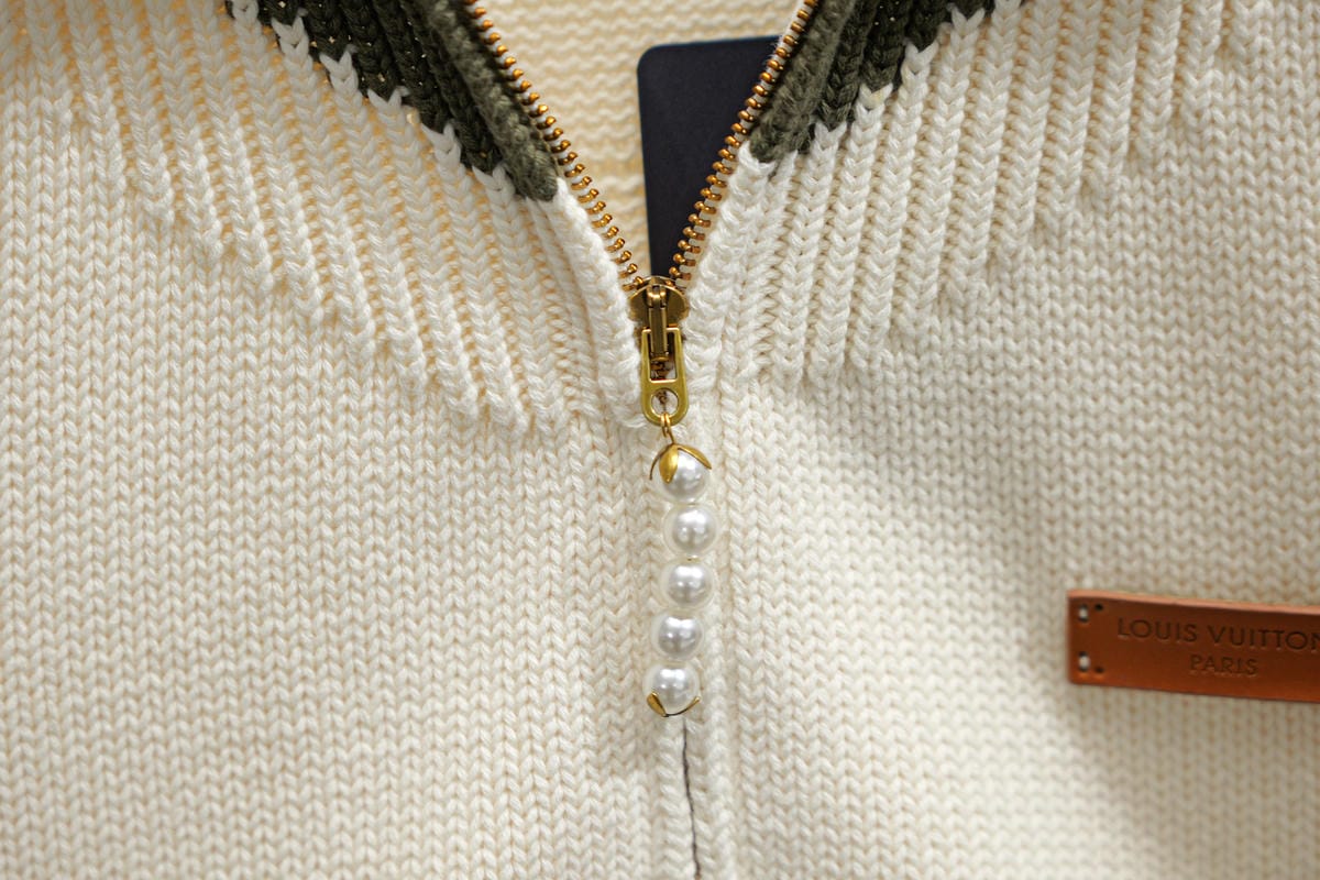 Ivory knit zip front with pearl bead trim and gold zipper pull