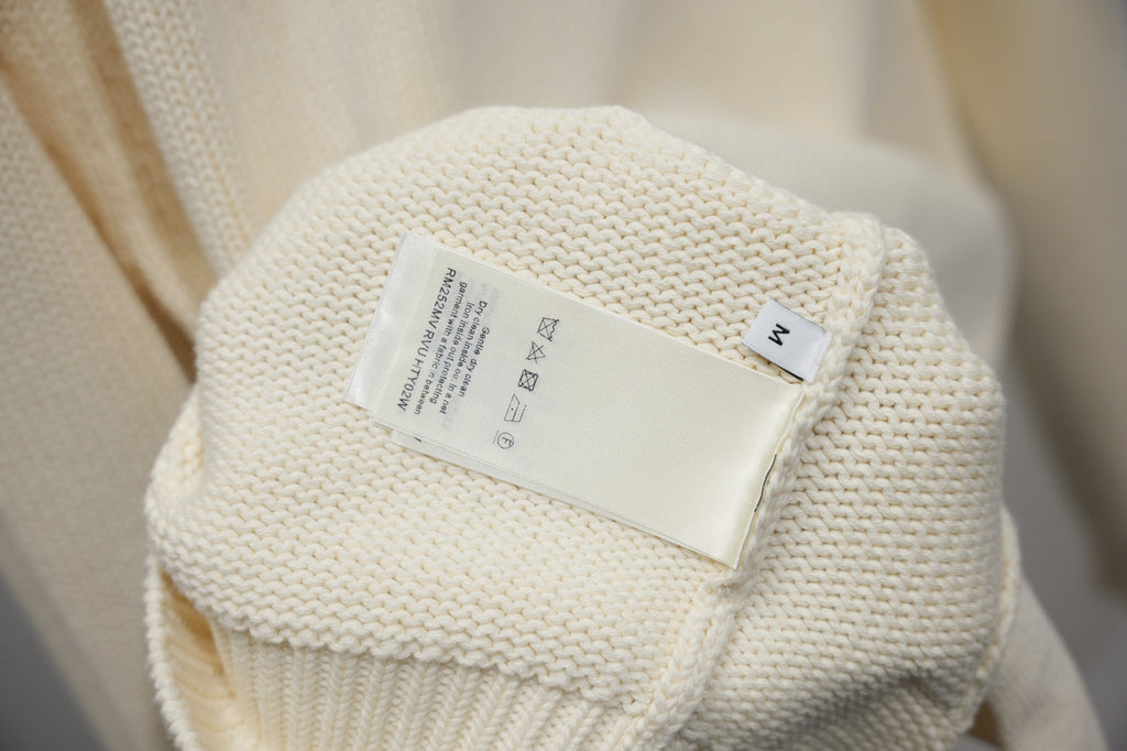 Ivory knit jacket care label on inner neck seam
