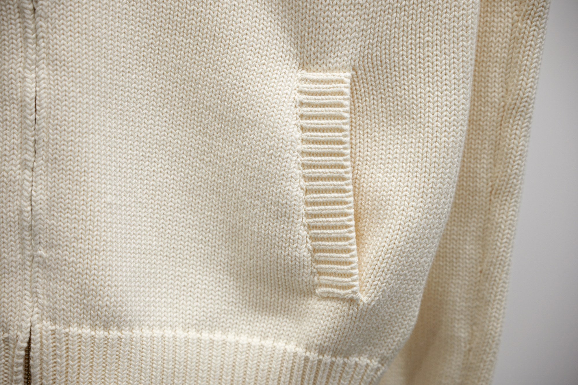 Ivory knit zip-up panel with ribbed seam detailing