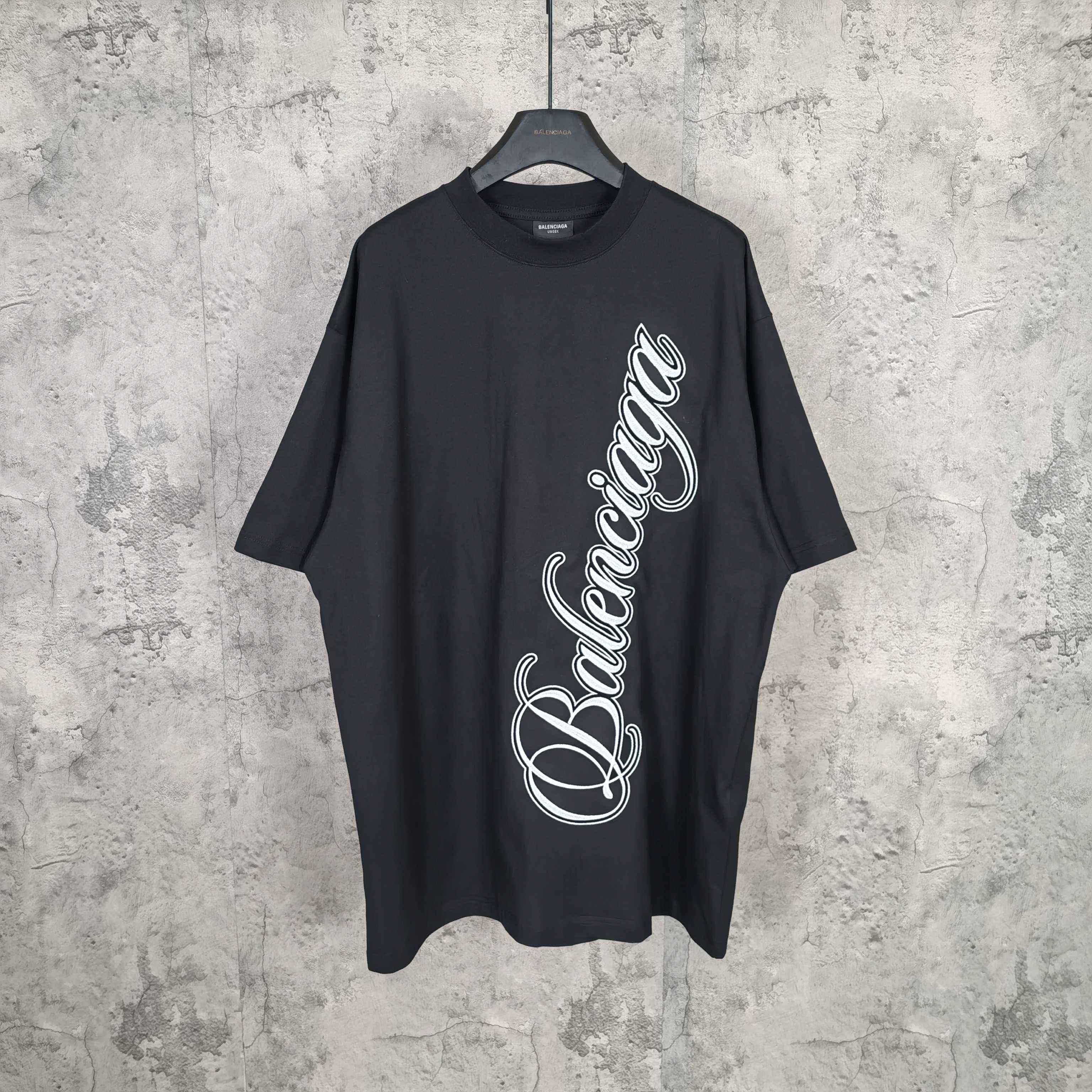 Balenciaga T-shirt in dark navy with large white script logo on the front
