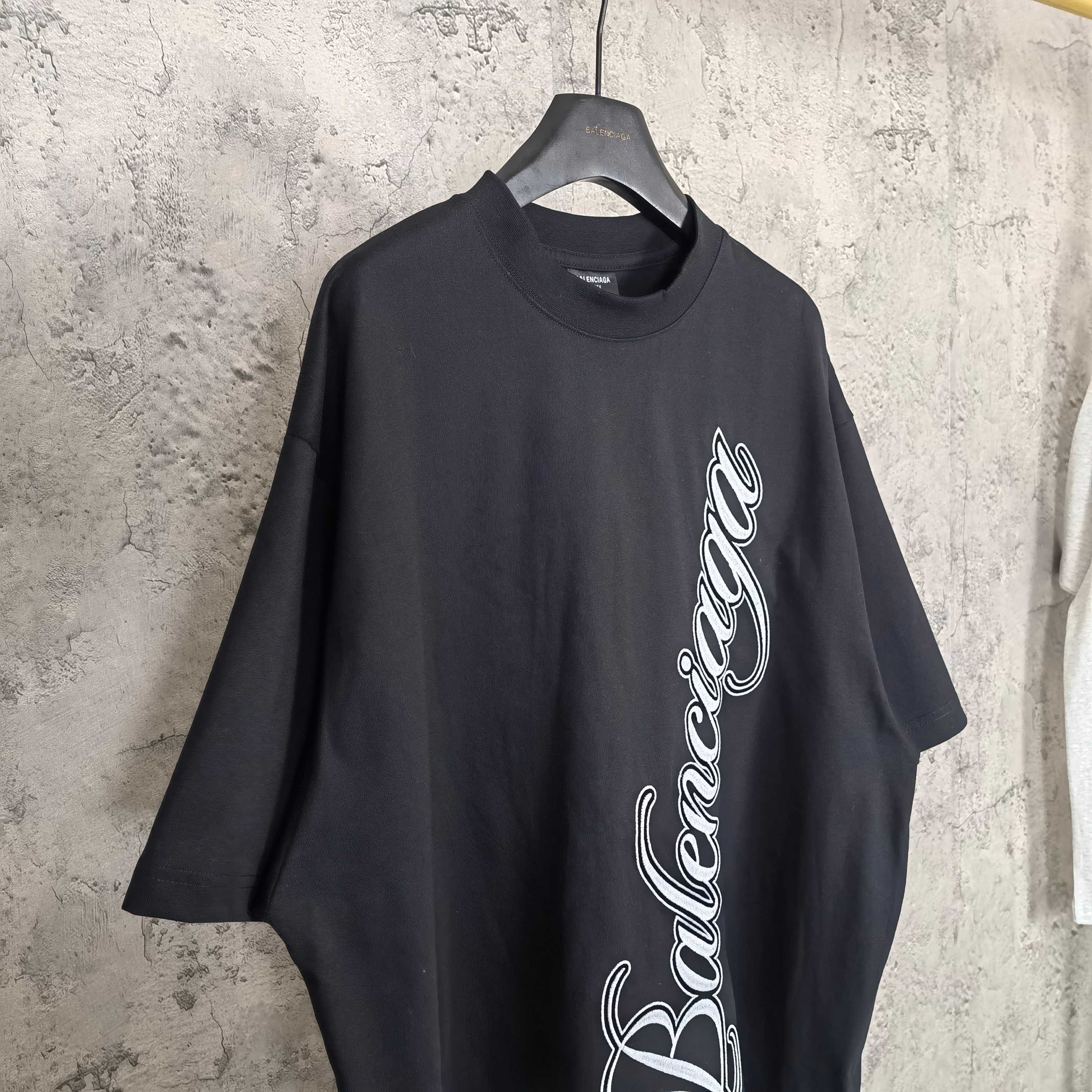 Balenciaga T-shirt in dark navy with white script logo on the chest