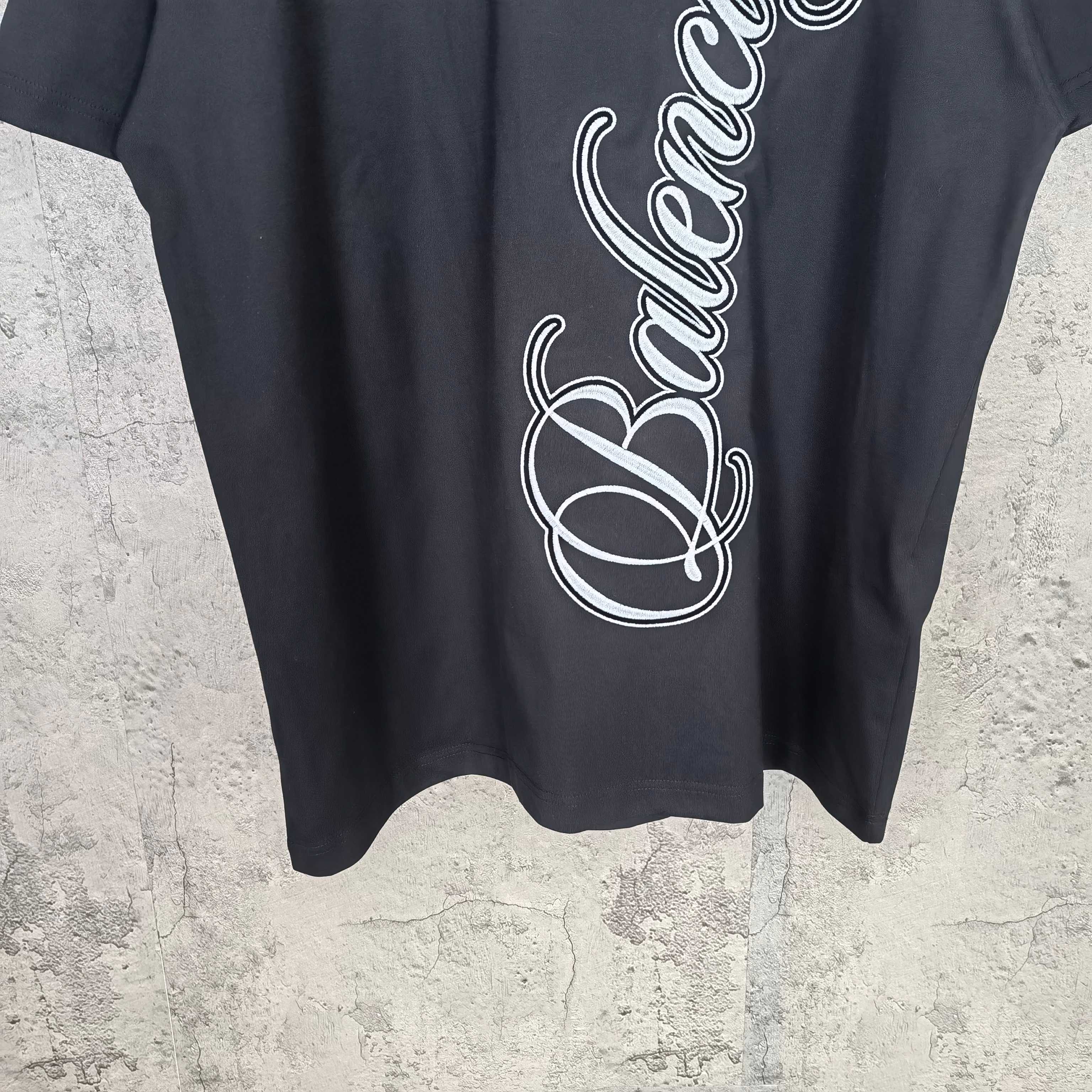 Balenciaga T-shirt front close-up with white script logo, crew neck visible