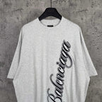 Balenciaga logo T-shirt in light gray with black script graphic on front
