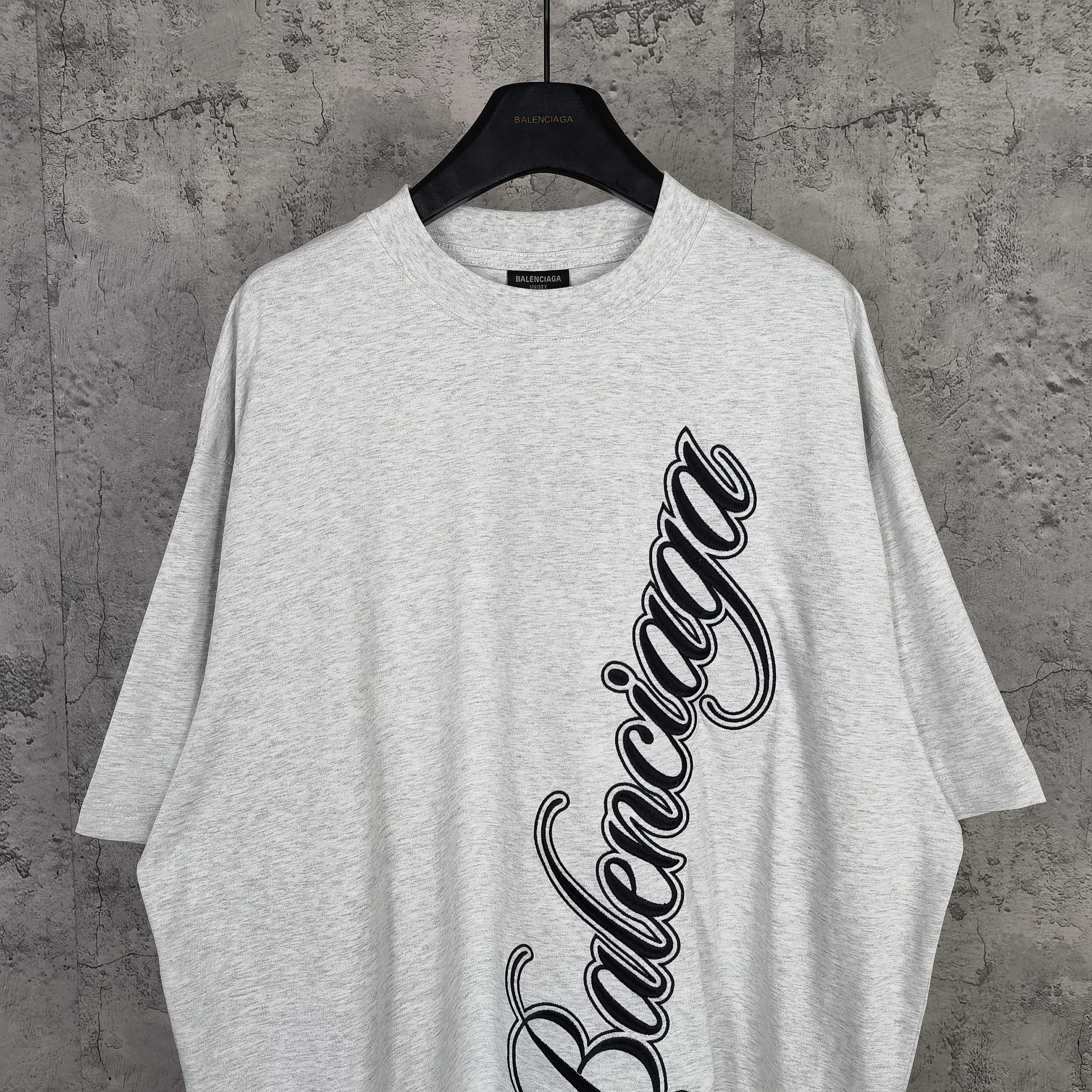 Balenciaga T-shirt, light gray, crew neck, black script logo front view.
