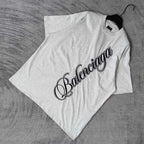 Balenciaga T-shirt, light gray, crew neck, short sleeves, black script logo, folded.