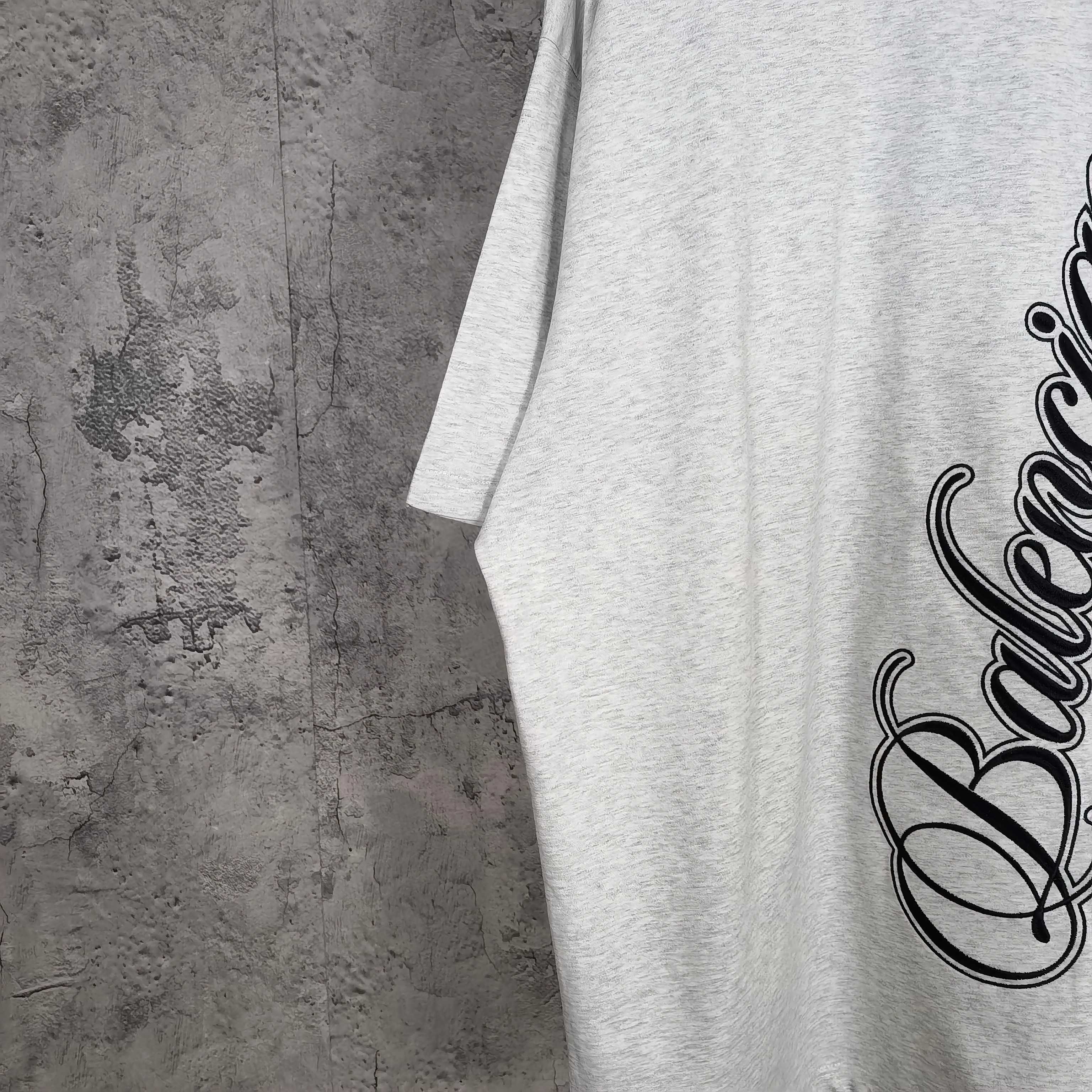 Balenciaga script logo T-shirt detail on light gray fabric