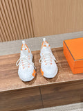 Hermes unisex sneakers in white with orange trim and chunky rubber sole.