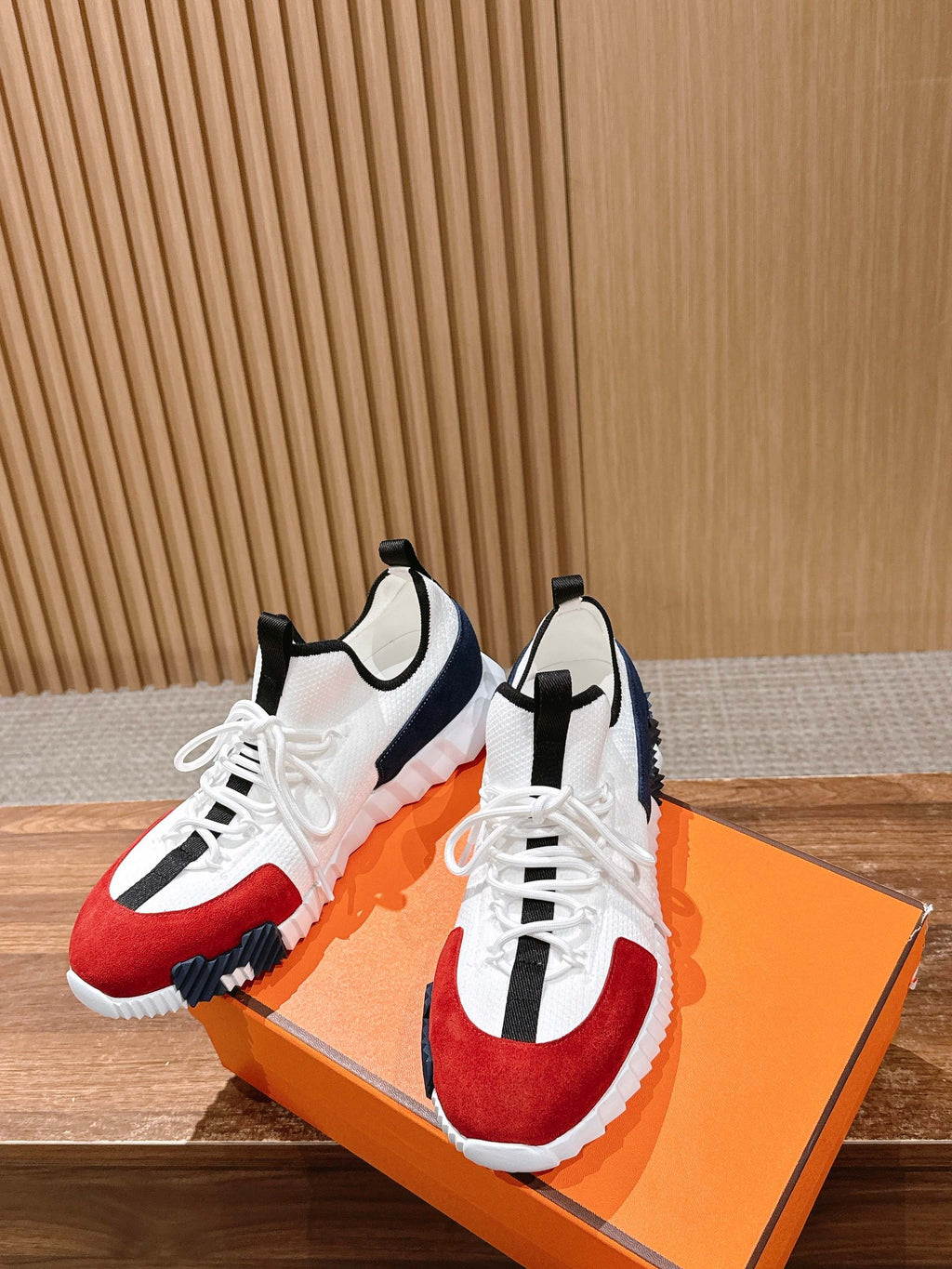 Unisex sneakers with white mesh, red and navy color blocks, black heel pull, on box