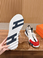 Unisex sneaker outsole view with blue tread lines, paired with red-and-navy upper shoe