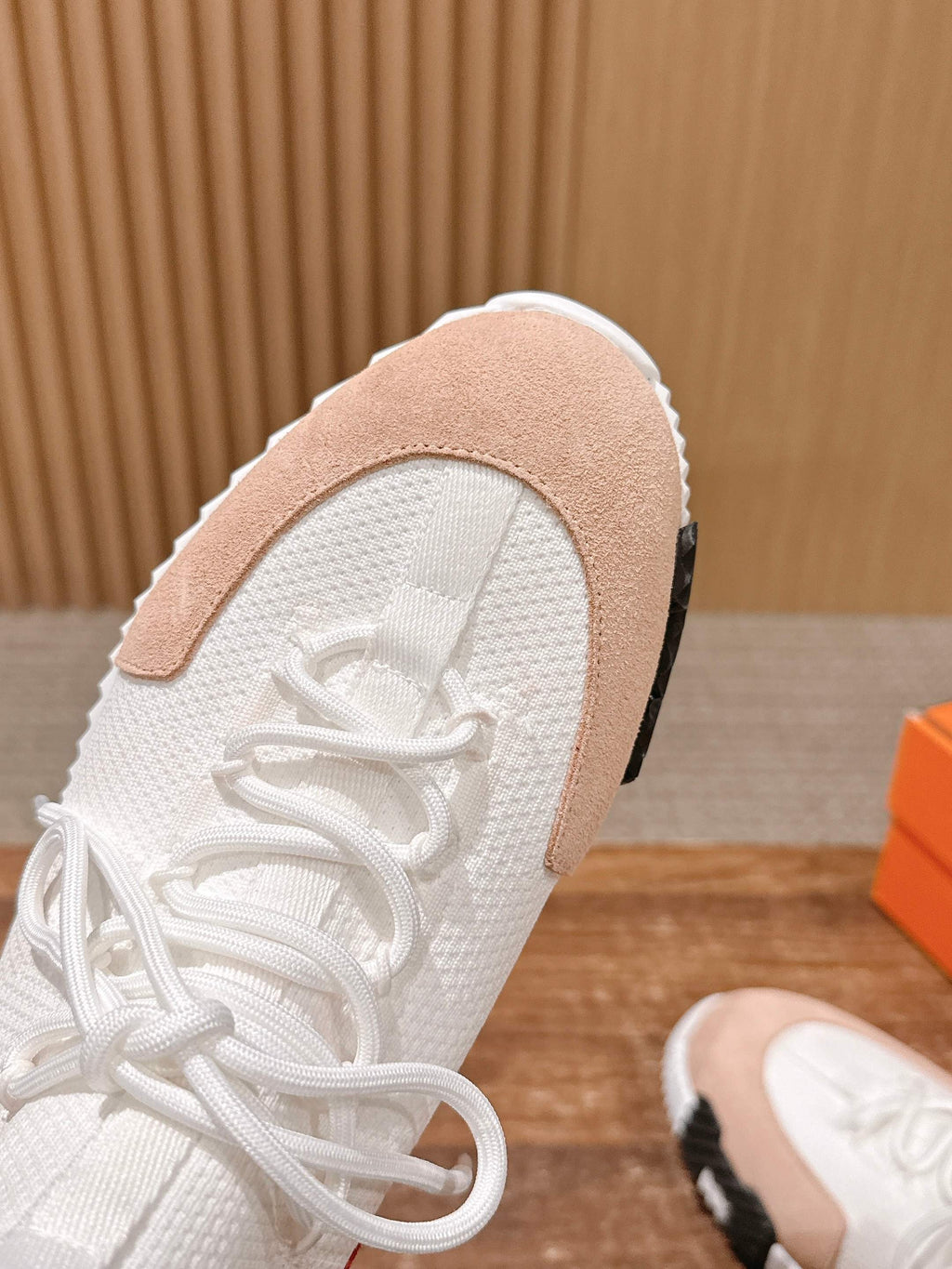 Hermes unisex sneakers, close-up white knit upper with beige suede collar and laces