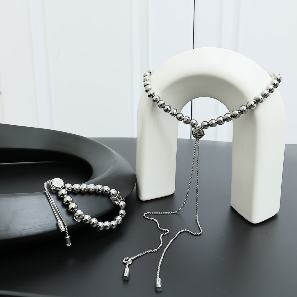 Louis Vuitton beaded necklace set with round silver beads and two tassel ends