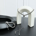 Louis Vuitton beaded necklace set with round silver beads and two tassel ends