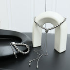 Louis Vuitton beaded necklace set with round silver beads and two tassel ends