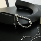 Louis Vuitton beaded bracelet with round silver beads, chain tassel, and LV charm