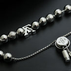 Louis Vuitton beaded necklace with round silver beads, LV charm, and flower medallion
