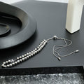 Beaded necklace with silver-toned spherical beads and fine chain, with small clasp end