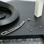 Beaded necklace with silver-toned spherical beads and fine chain, with small clasp end