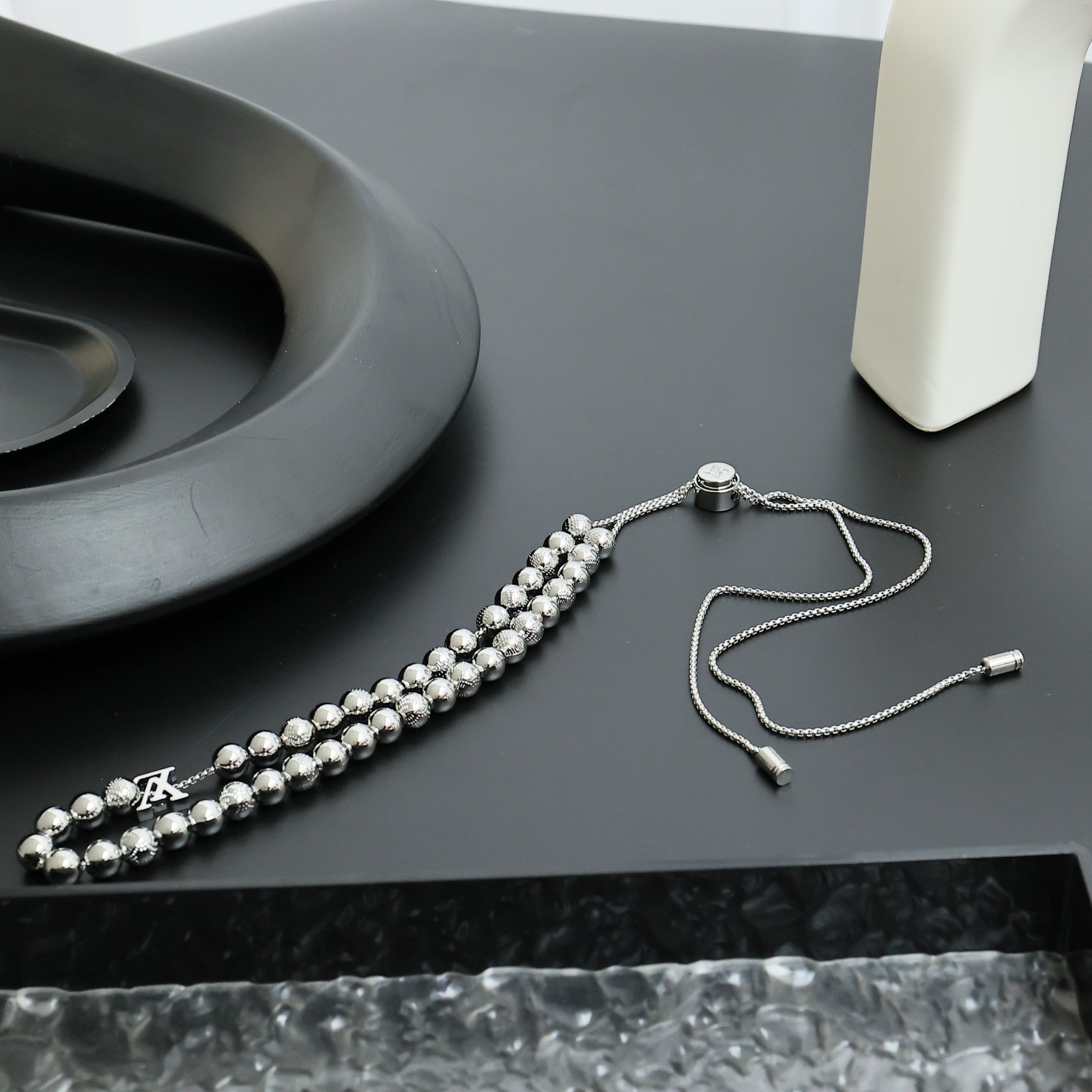 Beaded necklace with silver-toned spherical beads and fine chain, with small clasp end