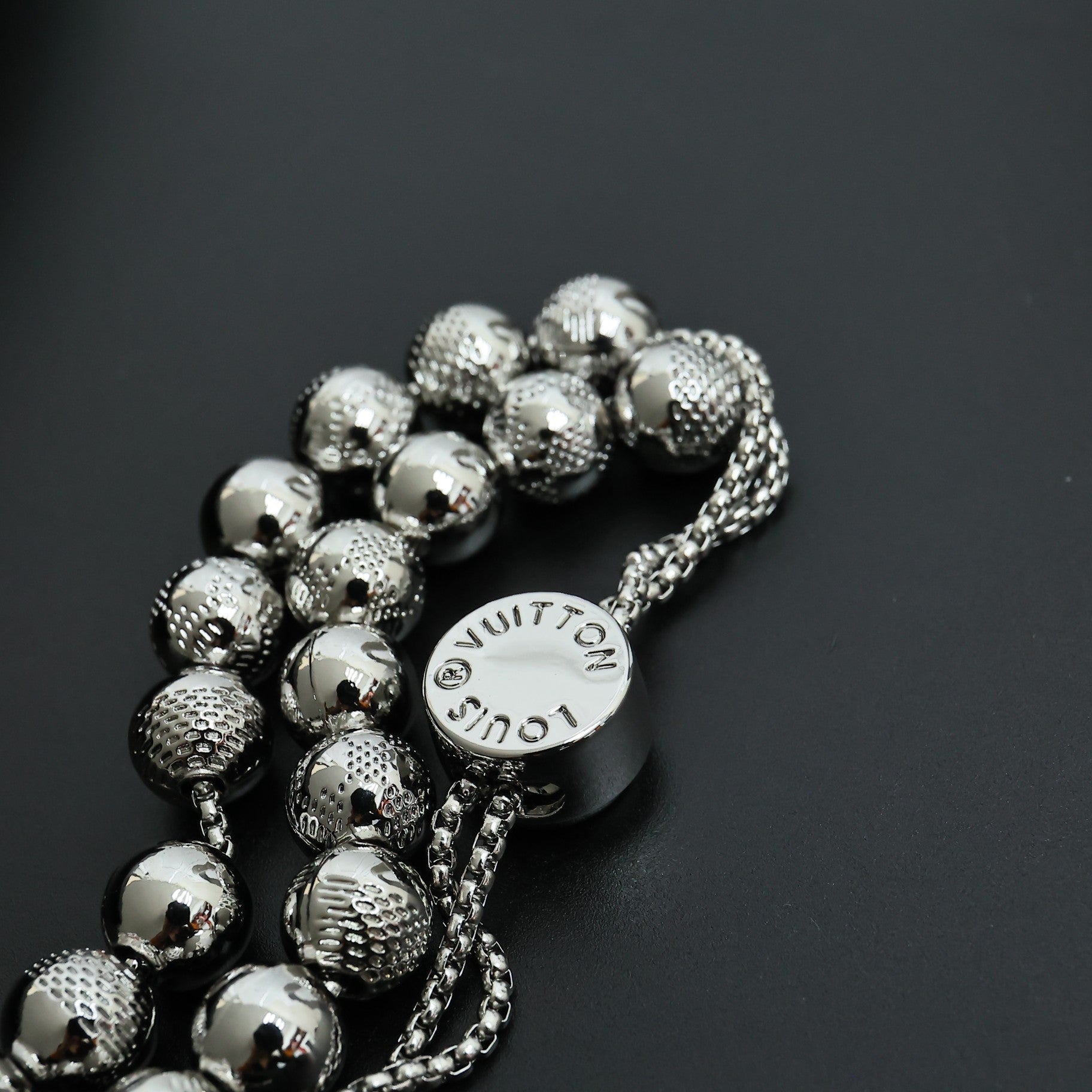 Beaded necklace with round logo charm and silver-toned spherical bead strands