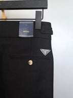 Black trousers with Prada logo patch and belt loop near waistband
