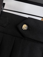 Black pants with front button and tailored pocket flap detail