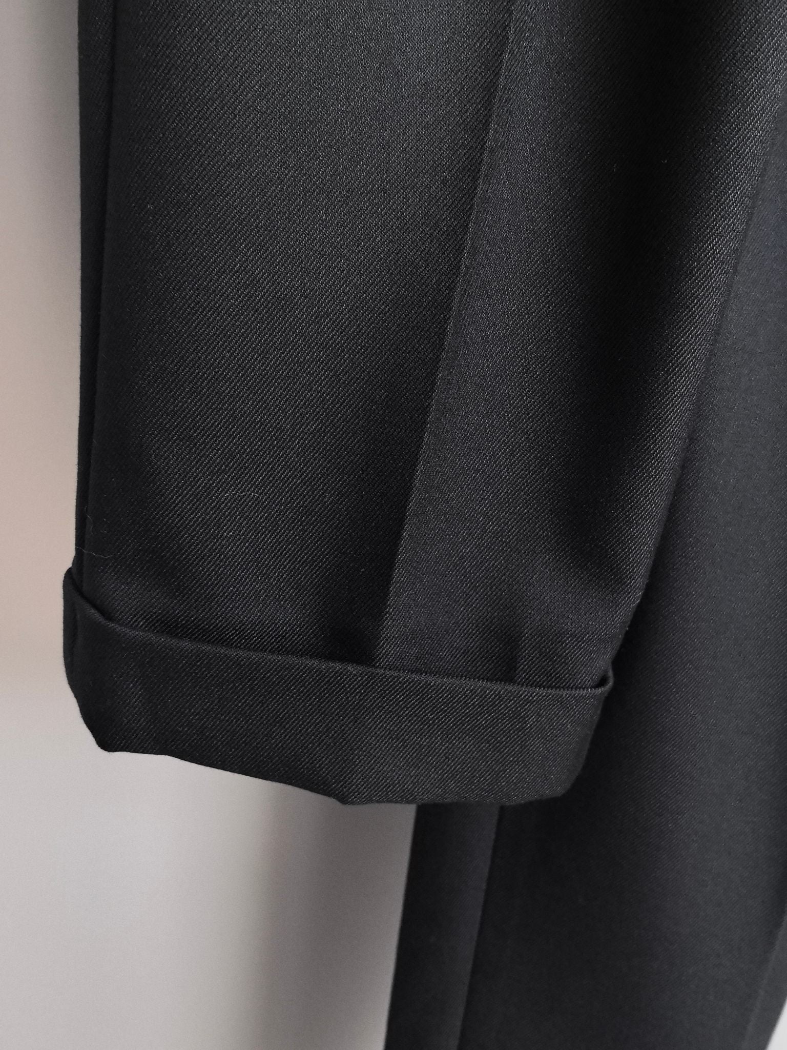 Black cuff and hem detail on tailored trousers