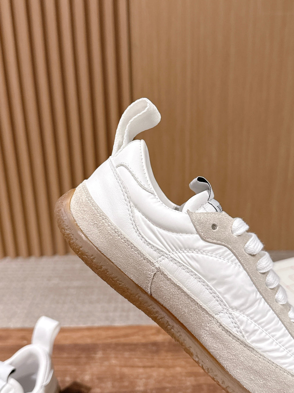 White leather sneaker with beige side stripe and lace-up front