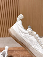 White leather sneaker with beige side stripe and lace-up front