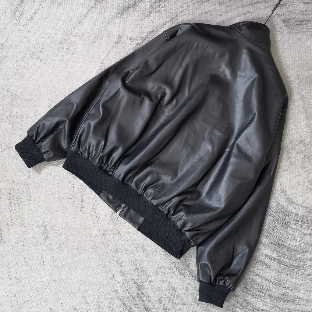 Black leather jacket with ribbed cuffs and hem, back view