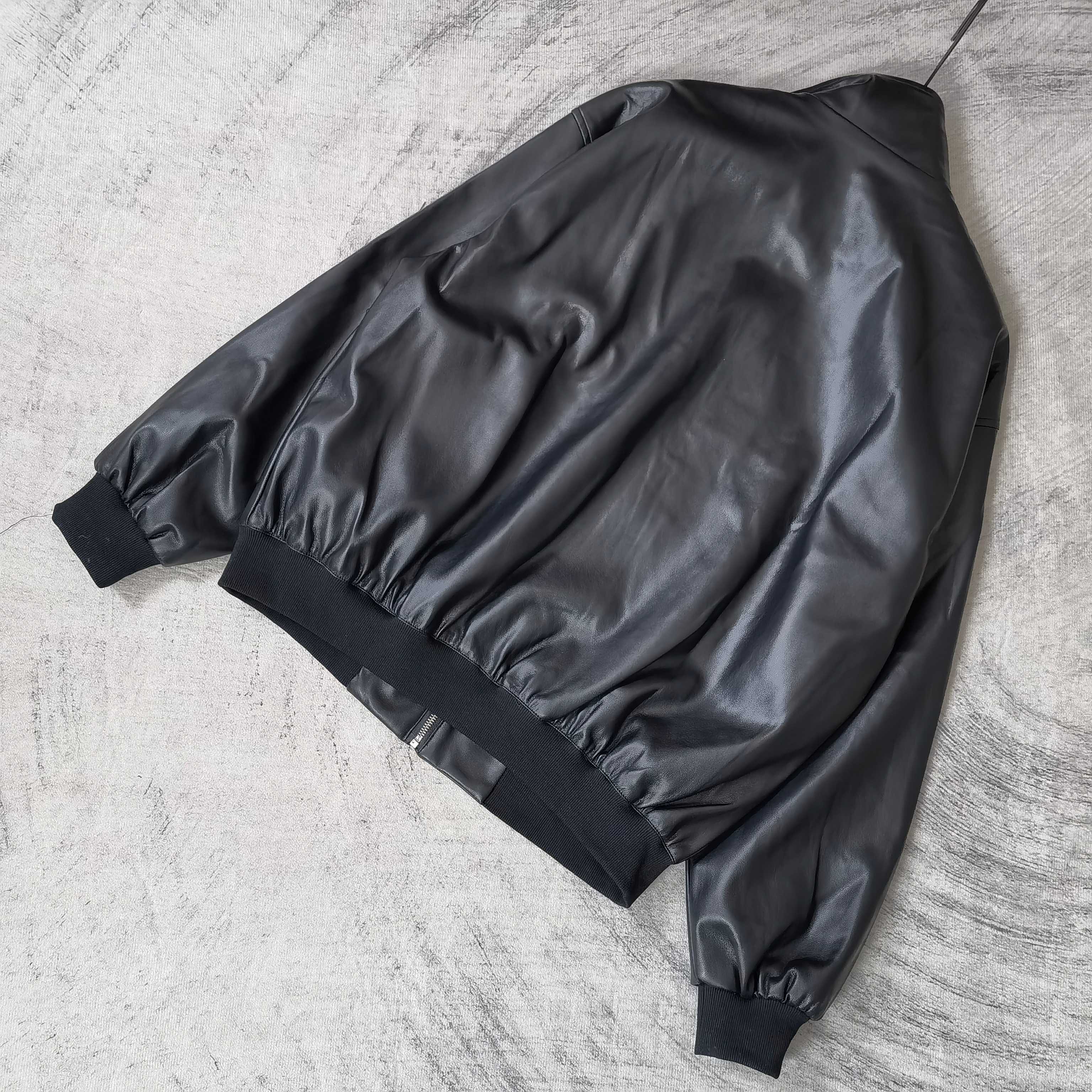 Black leather jacket with ribbed cuffs and hem, back view